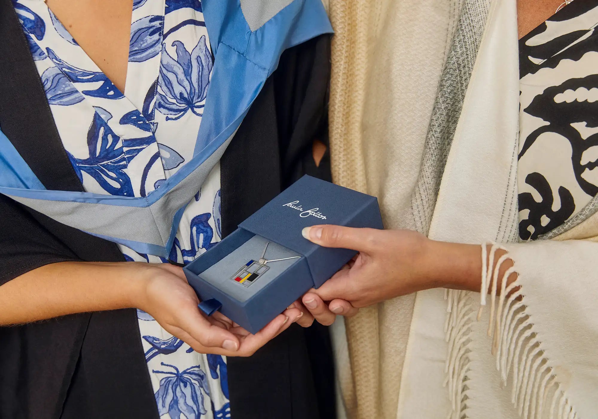 mother gifting daughter graduation jewellery present