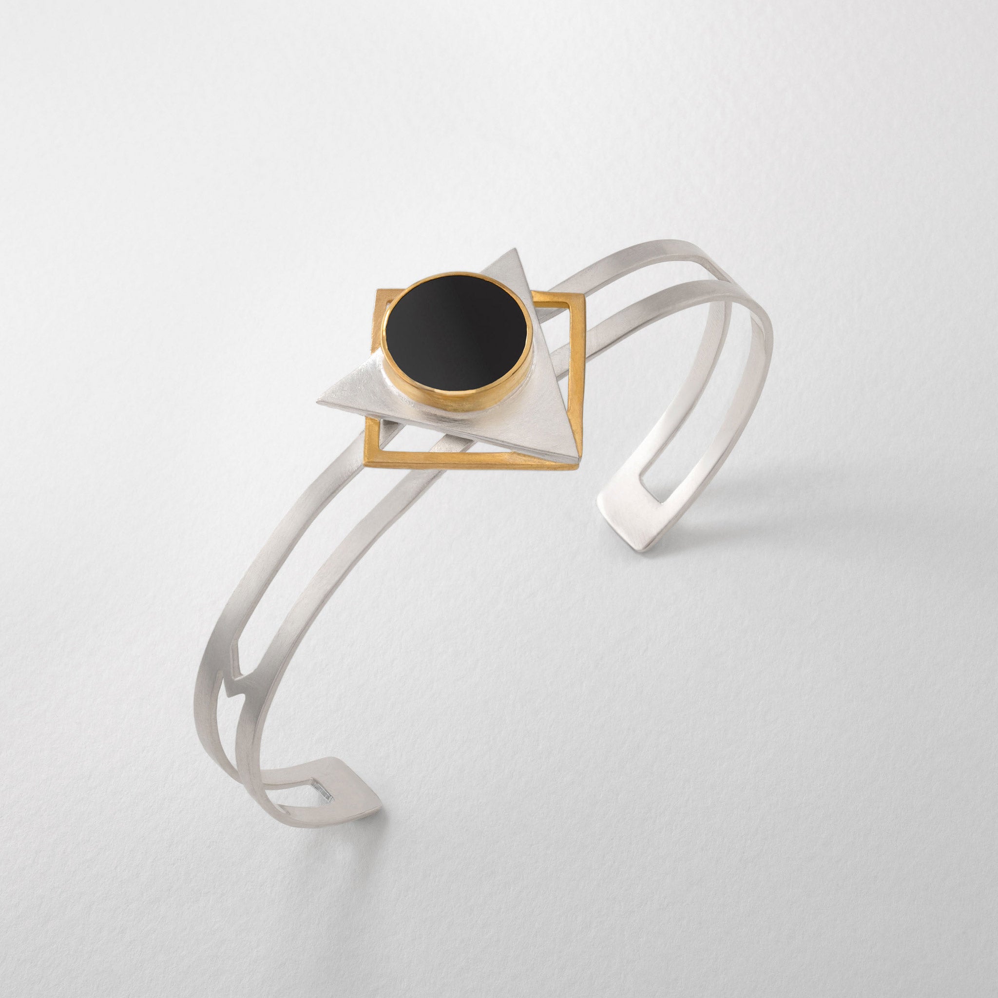 Silver statement bangle with Klimt art inspired design. Geometric ladies cuff bangle in silver gold and black resin.