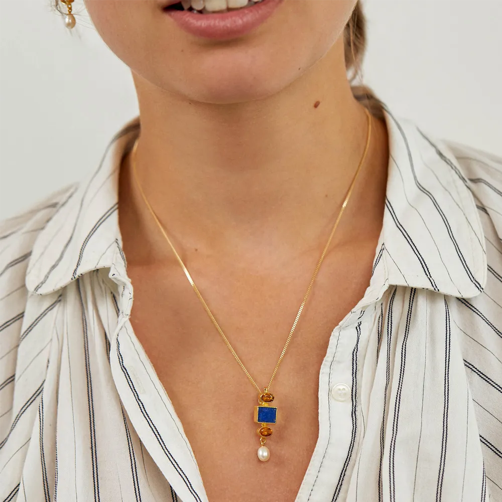 Young woman wearing Vermeer inspired Citrine necklace in sterling silver, 18ct gold, lapis lazuli and pearl.