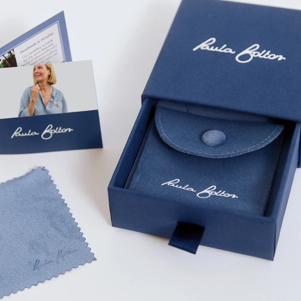 Blue jewellery box with 'Paula Bolton' branding, including a card and cloth